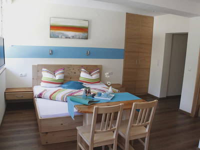 Das mit sehr viel Liebe eingerichtete 27m² große Zimmer „Winter“ mit Vollholzschlafzimmer, Dusche-WC getrennt und Blick auf den lebenden 